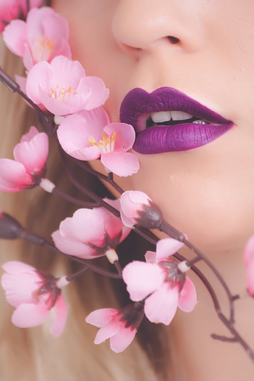 woman showing her purple lipstick